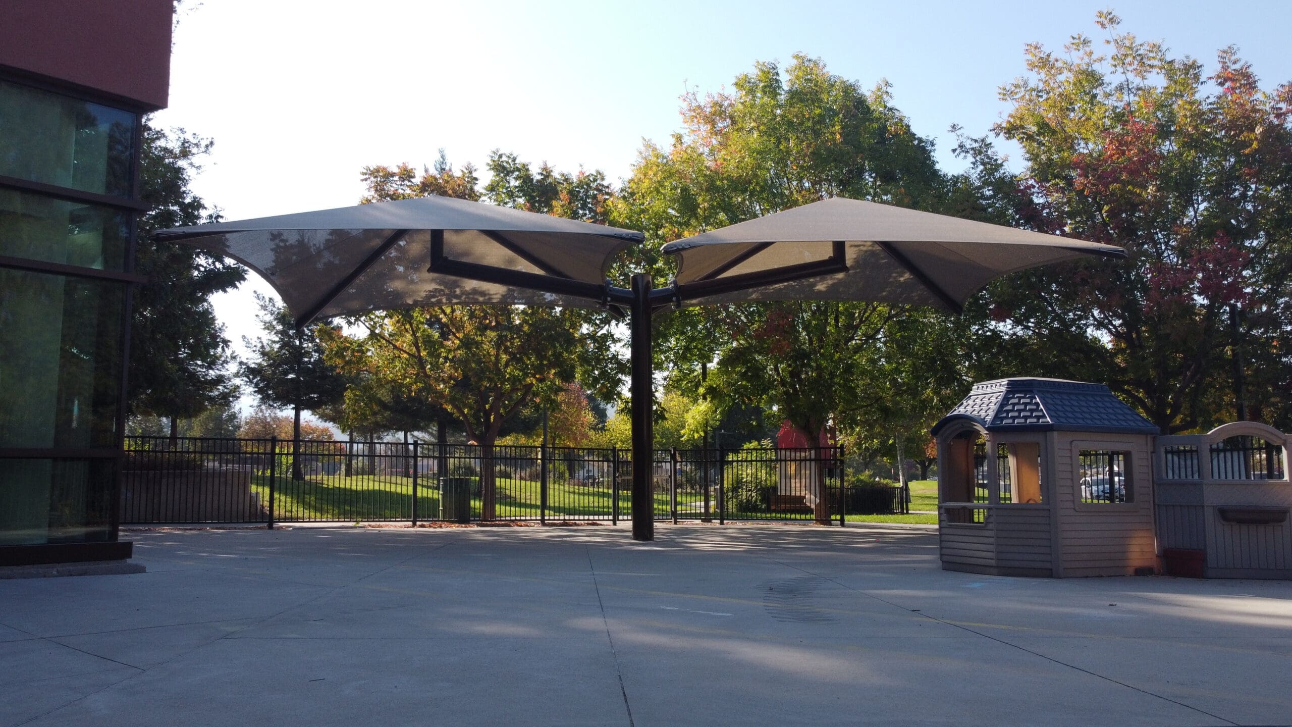 Single post pyramid cantilever shade structure covering Almaden Community Center in San Jose, CA