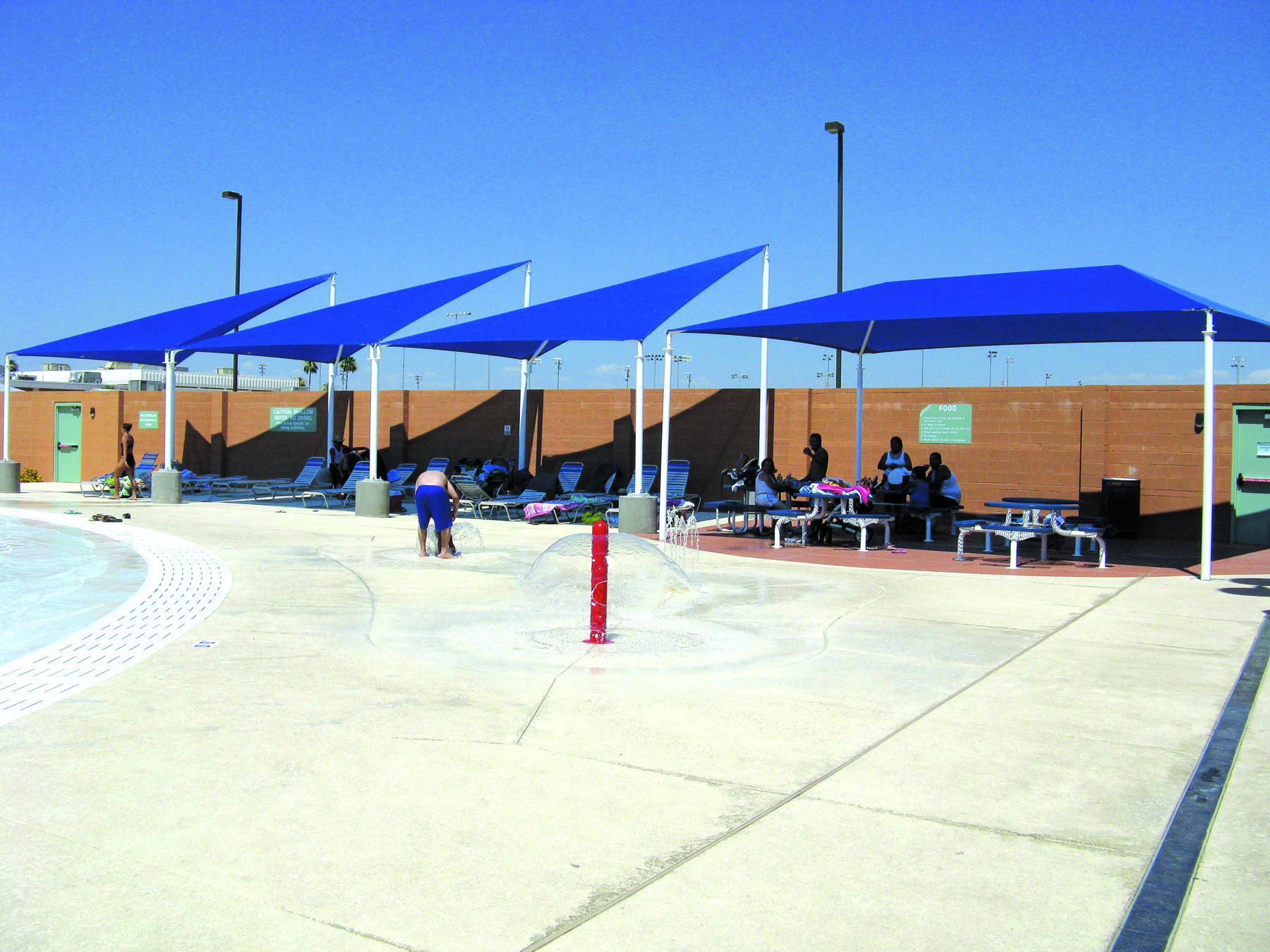Sun shade structures covering pool seating at Carson Junior High School