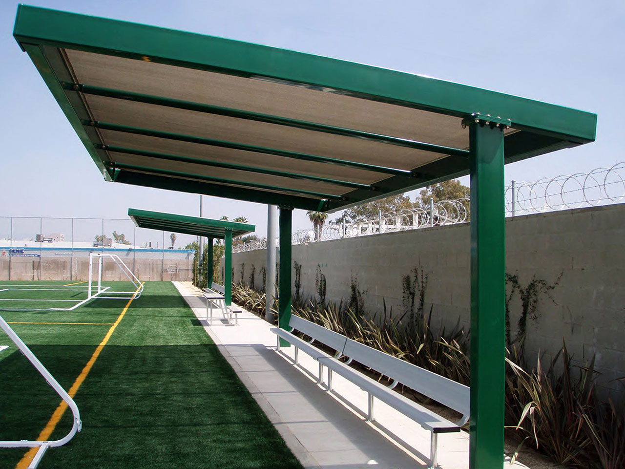 Cantilever shade structure covering benches at Delano Park